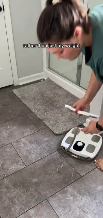 A creator positions the InBody device on the floor and handles its measurement bar.