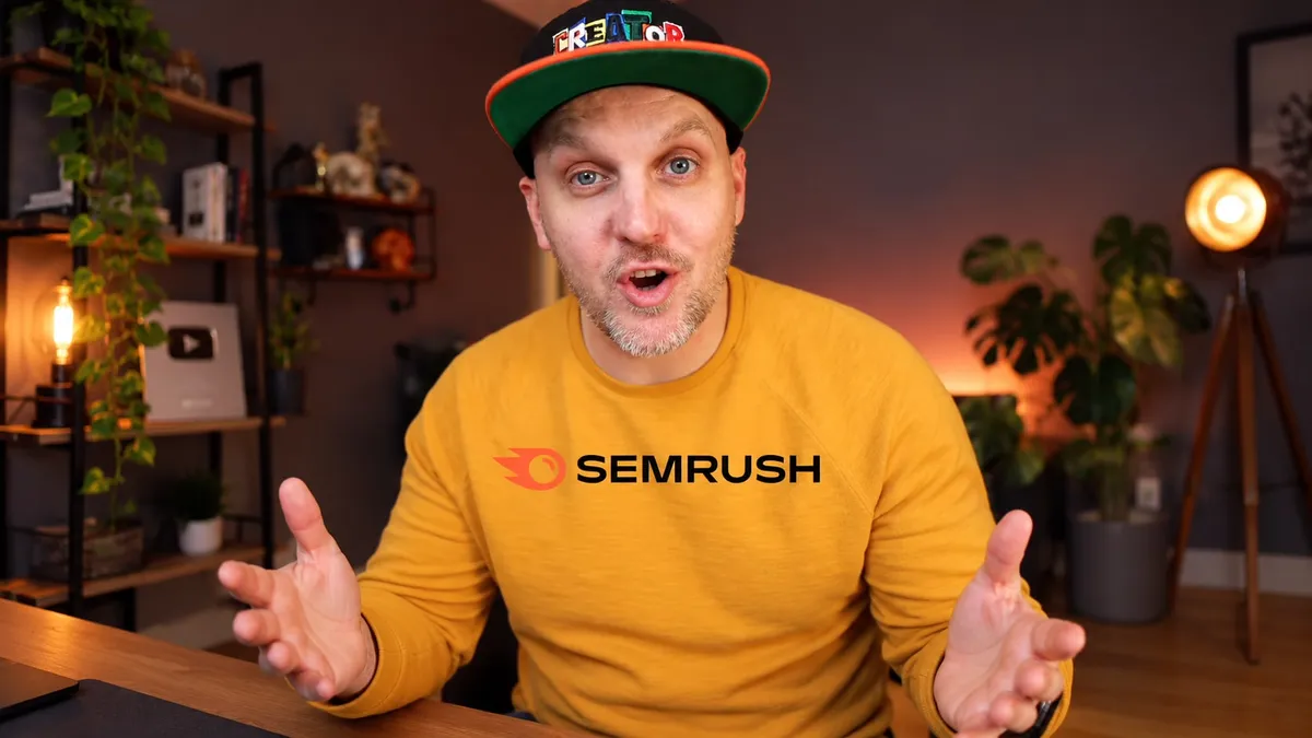 Creator in a Semrush sweater explaining the product to camera in his studio