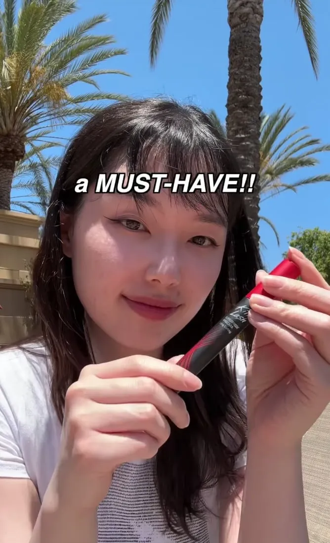 A creator presents CLIO mascara outdoors in another execution from the same Prime Day campaign.