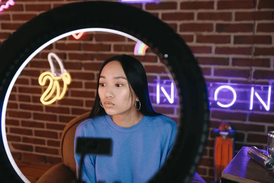 A creator framed by a ring light