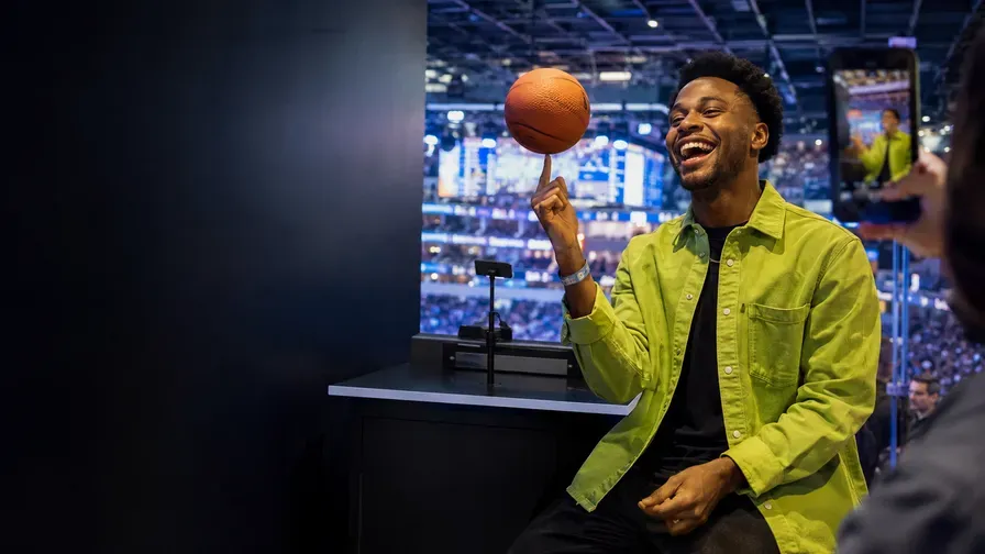A creator spinning a basketball in an arena studio