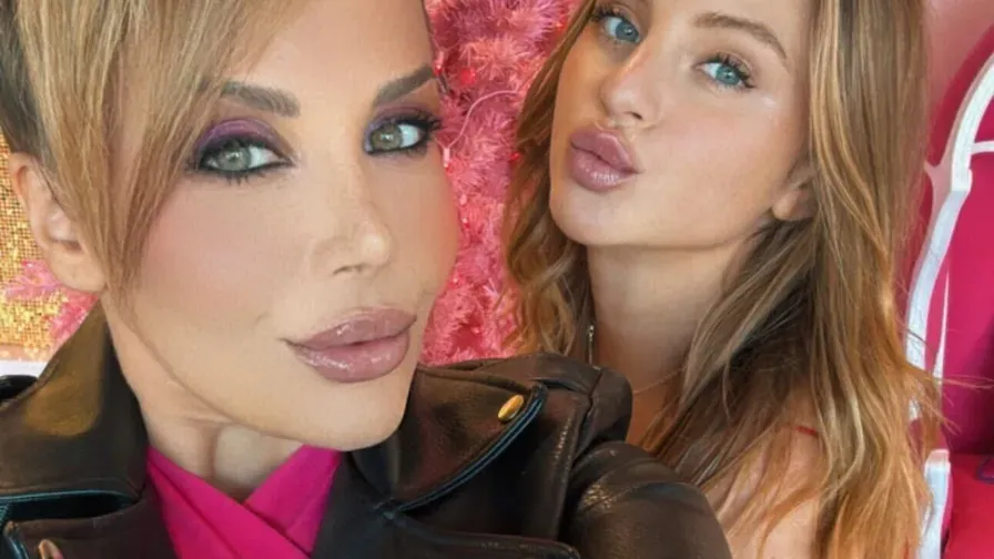 Two creators in a selfie by a pink tree