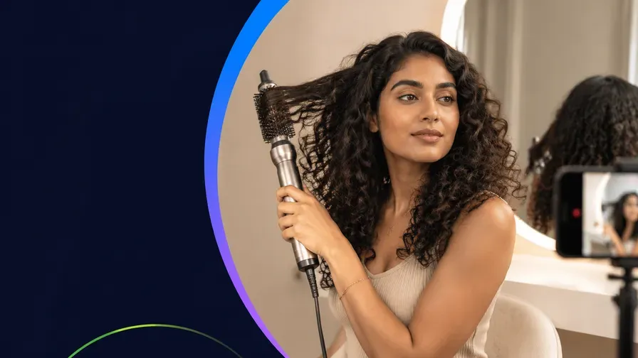 A creator styling her hair with a hot brush