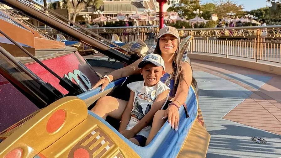 Krystalyn Laura on a theme-park ride with a child