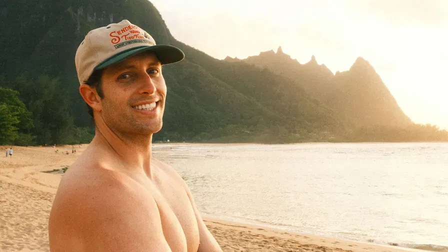Kyle LaClaire on a beach at sunset