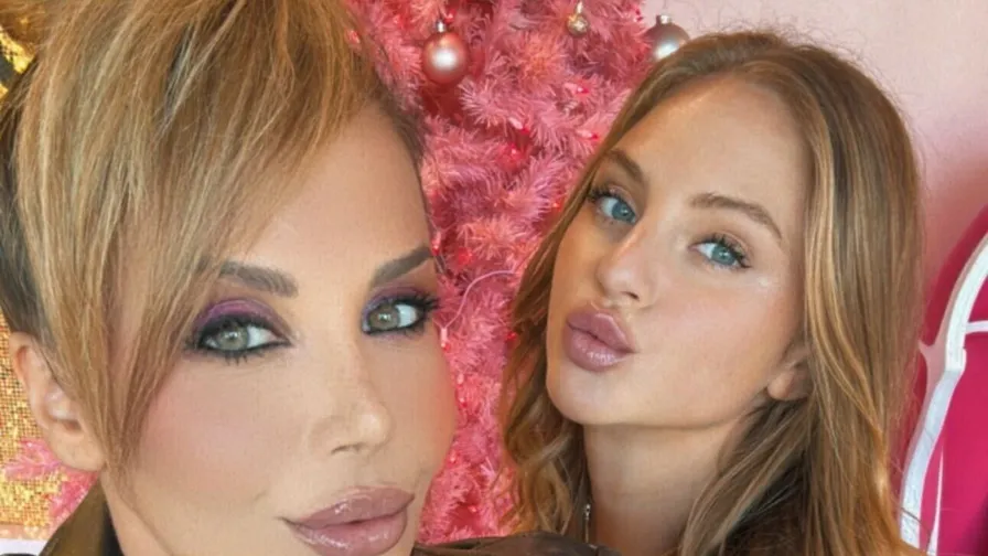 Two creators in a selfie by a pink tree